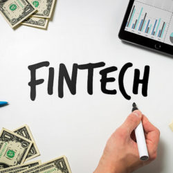 Money and charts and the word FinTech.