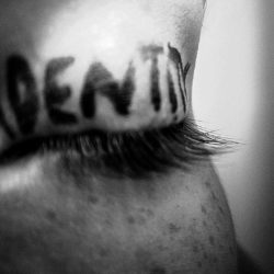 The word identity written on an eyelid.