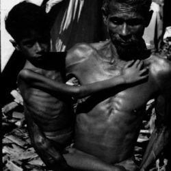 A man and a child starving, an example of the danger of food insecurity