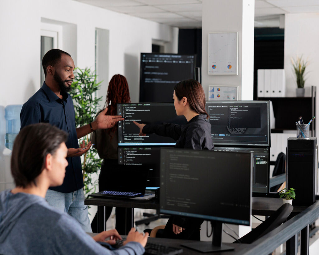 Technology professionals around computers
